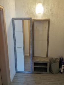 a mirror sitting on a wall next to a table at Apartments Lucic in Senj +34 photos