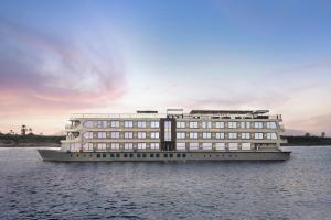 a large building in the middle of the water at Historia The Boutique Hotel Nile Cruise - Every Monday from Luxor for 04 & 07 Nights - Every Friday From Aswan for 03 & 07 Nights in Luxor