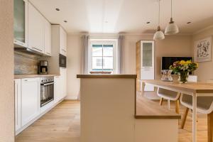 a kitchen with a table and a dining room at An de Dün in Dierhagen