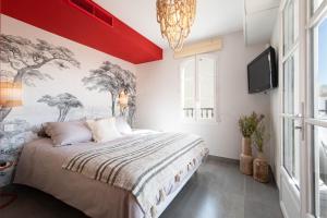 a bedroom with a large bed and a tv at Matelotte in Saint-Tropez