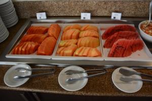 a buffet with a tray of different types of food at Rede Andrade Bello Mare in Natal