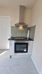 a kitchen with a stove top oven in a room at Dartford Kent House - Hosted by Castile Accommodations Ltd in Kent