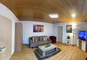 a living room with a couch and a table at Ferienhaus Wolle & Beate in Alken
