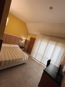 una camera d'albergo con letto e finestra di Hotel Valganna a Milano