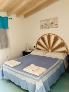 A bed or beds in a room at Residence Il Melograno