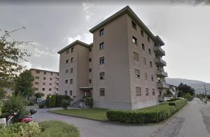a large apartment building in a city at Caslano City Apartments in Caslano