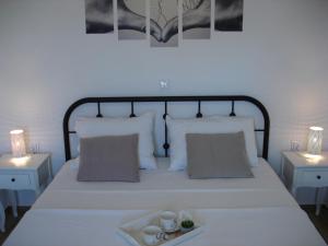 a bedroom with a bed with a tray of food on it at Dominik in Orebić