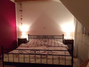 a bedroom with a bed with two lamps on two tables at Ferienwohnungen "Vieling" Objekt-ID 12155-9 in Waren