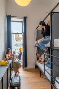 a group of people in a room with bunk beds at Intra Muros Hostel in Heraklio