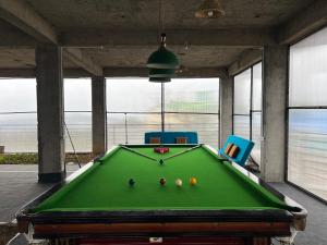 a pool table with balls on it in a room at Flyscape in Bīr
