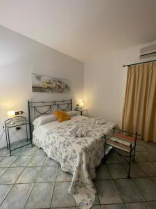 a bedroom with a bed and a table in it at Da Carmelo, Apartments & Rooms in Palinuro