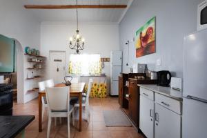 a kitchen with a table and a dining room at Karoo Huisie Bethulie at Karoo Pandok in Bethulie