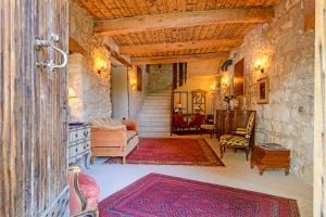 uma sala de estar cheia de mobiliário e uma parede de pedra em Bastide de Bellegarde em Avignon