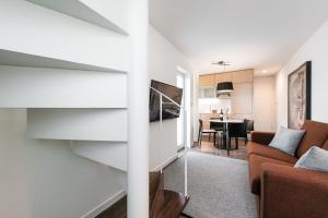 a living room with a couch and a dining room at Marques Design Apartments in Porto