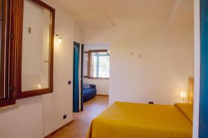 A bed or beds in a room at Residence I Faraglioni
