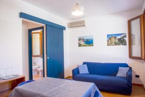 A bed or beds in a room at Residence I Faraglioni