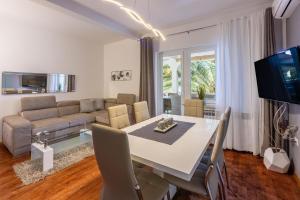 a living room with a table and a couch at Apartment Villa Zdenka in Crikvenica