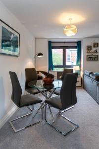 a living room with a glass table and chairs at BEST PRICE! Superb city centre apartment, 2 Superkings or 4 singles Smart TV & Sofa bed- FREE SECURE PARKING in Southampton