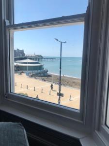 a window with a view of a beach and the ocean at Cranwell Court Apartments in Aberystwyth