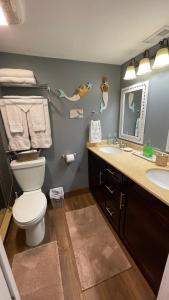 a bathroom with a toilet and a sink at Excellent beach front community, golf course, tennis, sunny weather year round! in Fort Pierce