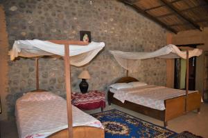 Ένα ή περισσότερα κρεβάτια σε δωμάτιο στο Mango Tree Lodge