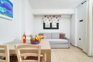 a living room with a table and a couch at Serenity Apartments in Skala Potamias