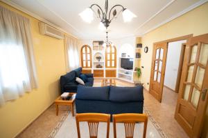 a living room with a blue couch and a table at TOLEDO A TIRO in Bargas