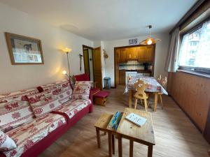a living room with a couch and a table at Resse - Appartement 3 pieces centre in La Clusaz