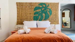 a bedroom with a large orange bed with white pillows at Bono Hotel Old Town in Marmaris