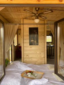 a bed with a tray of food on top of it at Rajski Domek in Sadowie +17 photos