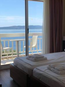 a bedroom with a bed and a view of the ocean at Villa Gradina in Baška Voda