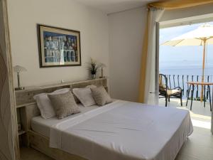 a bedroom with a bed with a view of the ocean at Beach house Sveti Jakov in Dubrovnik