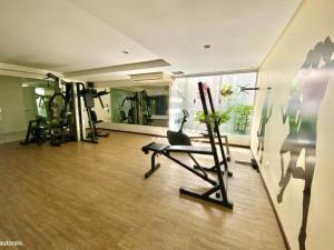 a room with a gym with a treadmill at Flat espaçoso na orla de Tambaú - Nobile Suítes in João Pessoa
