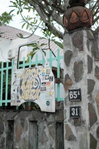 a bag hanging on a stone wall with a sign at Abrakadabra 747 in Timuran
