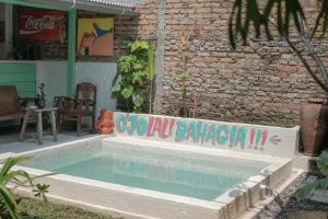 a swimming pool in front of a brick building at Abrakadabra 747 in Yogyakarta