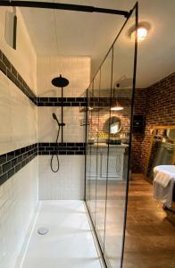 a shower with a glass enclosure in a bathroom at Serendipity Eymet B&B in Eymet