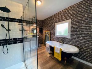 a bathroom with a sink and a glass shower at Serendipity Eymet B&B in Eymet