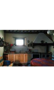 a kitchen with a sink and a window at Casa Vacanze Al Colletto - Con terrazza panoramica in centro storico in Vagli di Sotto