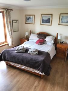 a bedroom with a bed with two towels on it at Druid View B&B in Inverness