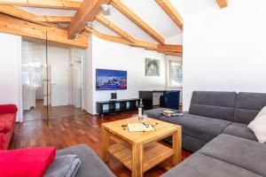 a living room with a couch and a table at Chalet Habachtal - Wildkogel in Bramberg am Wildkogel