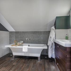 a bathroom with a bath tub and a sink at The Castle Hotel, Conwy, North Wales - The Coaching Inn Group in Conwy
