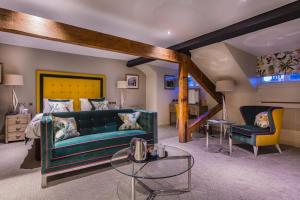 a living room with a green couch and two chairs at The Castle Hotel, Conwy, North Wales - The Coaching Inn Group in Conwy