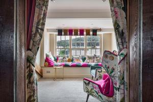 a living room with a couch and a window at The Castle Hotel, Conwy, North Wales - The Coaching Inn Group in Conwy