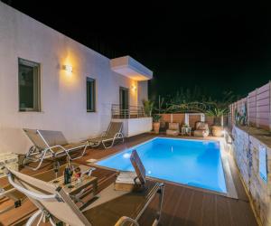 a swimming pool in the middle of a house at Villa Olive Tree in Pitsidia