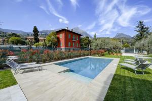 a backyard with a swimming pool and a house at Maison Bellini 2 in Toscolano Maderno