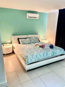 a bedroom with a bed with flowers on it at Las Islas Condo #1 in Palm-Eagle Beach +18 photos
