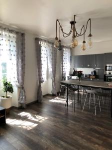 a kitchen with a table and a dining room at Appartement Centre Historique in Bergerac