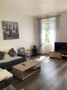 a living room with a couch and a table at Appartement Centre Historique in Bergerac