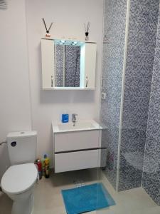 a bathroom with a toilet and a sink and a shower at Alina apartament 2 in Năvodari