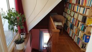 a staircase with bookshelves filled with books at Haus Wunderlich in Sigmaringen